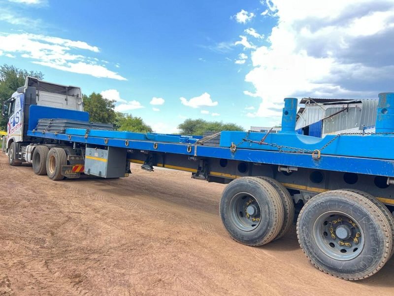Loaded flat-deck trailers ready for departure