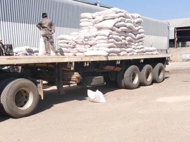 Flat-deck trailer loaded with bagged agricultural cargo